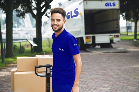 GLS delivery driver leaves a store with parcels to Deliver them