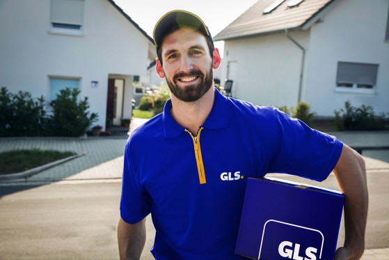 Happy driver getting out of van to deliver a parcel