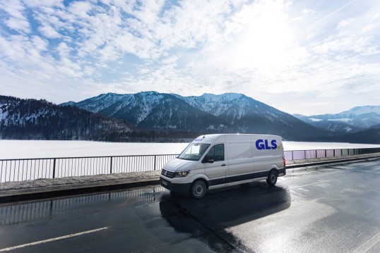 van in front of a lake