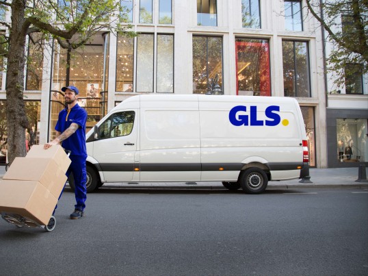 GLS van and a courier on their way to recipients